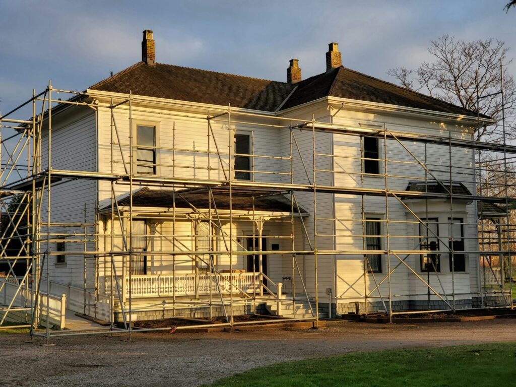 White two-story home under renovation with scaffolding, Maryland and Washington, DC area.
